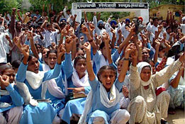 Students raise slogans to protest the decision of transferring teachers from local government senior secondary schools to other schools
