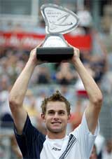 Andy Roddick of the US hoists the winner's trophy following his 6-1, 6-3 victory over David Nalbandian of Argentina 
