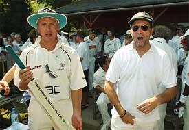 British musician Eric Clapton and England wicket-keeper Alec Stewart strike a pose