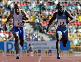 Frank Fredericks of Namibia and John Capel from the US cross the finishing line in the men's 100m final 