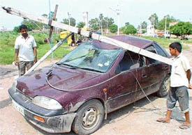 This electricity pole fell on this Maruti Esteem car and damaged the vehicle