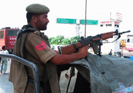 A cop stands guard near the Maulana Azad Stadium, the venue of Independence Day celebrations, 