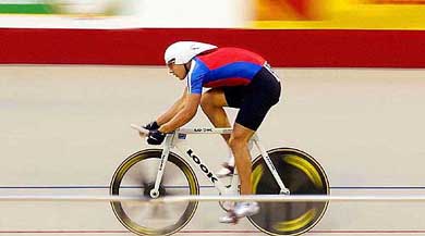 Cuba's Ahmed Lopez rides on his way to set a new Pan American Games record in the men's 1km cycle race