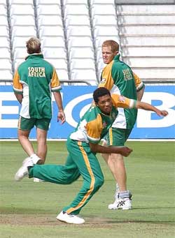 South African fast bowler Shaun Pollock watches teammate Makhaya Ntini 