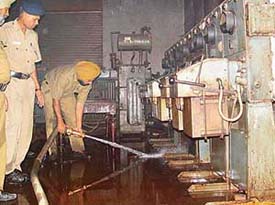 A fireman directs a water jet to control a fire which broke out in the LIC building in Sector 17