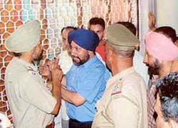 Traders enter into an altercation with the police when stopped from forcing shopkeepers to down shutters in Sector 17, Chandigarh, on Thursday.