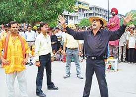Director Rajiv Mehta enacts a sequence in the play "Shaheed Ki Waapsi" presented by Theatre Arts on the eve of Independence Day at Sector 17 
