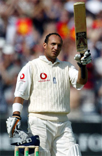 England�s Mark Butcher raises the bat after reaching his century 