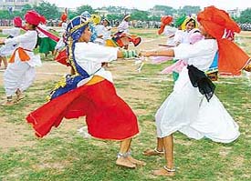 Girls present Haryanvi dance at an Independence Day function at Prade Ground