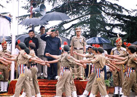Himachal Pradesh Chief Minister Virbhadra Singh takes the salute during a marchpast 