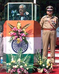 Jammu and Kashmir Chief Minister Mufti Mohammed Sayeed speaks from behind a bullet-proof glass