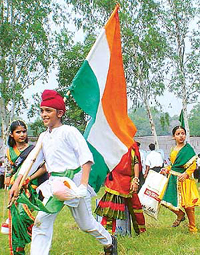 A boy rushes for the venue to take part in Independence Day celebrations in Ludhiana on Friday.