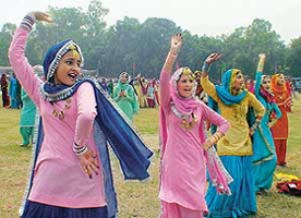 Schoolchildren present items during a district-level Independence Day celebration