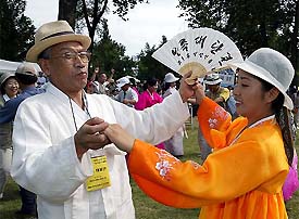 A North Korean woman dances with a South Korean man during a unification rally in Pyongyang 