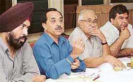 Mr Jagdish Arora, president, Chandigarh Beopar Mandal (second from left), addresses a press conference in Sector 35, Chandigarh