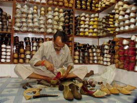 A shoemaker at work at a shop in Kucha No-11, Field Ganj