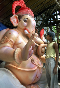 An artisan paints an idol of Lord Ganesha at a workshop in Mumbai 