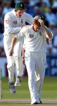 South Africa's Shaun Pollock with captain Graeme Smith after taking the wicket of England's Marcus Trescothick