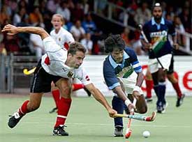 German player Elke Duckwitz tries to stop India�s Dhanraj Pillay