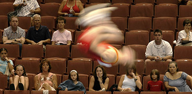 Fans watch German gymnast Stephan Zapf fly through the air in the men's vault team event at the World Gymnastics Championships