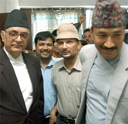 Nepal government's peace talk negotiators Prakash C. Lohani and Kamal Thapa welcome Maoist negotiators Baburam Bhattari and Krishna Bhadur Mahara before the start of peace talks 