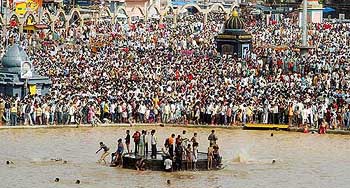 Devotees take holy dips in the Godavari river on the occasion of Kumbh Mela 