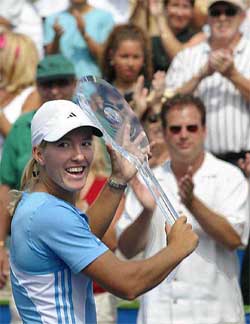 Justine Henin-Hardenne of Belgium shows her trophy after winning the Rogers AT&T Cup in Toronto