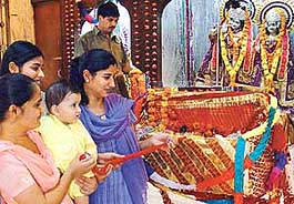 A little one pulling the cradle of Lord Krishna on the occasion of Janmashtmi at Sanatan Dharam Mandir, Sector 46, in Chandigarh on Tuesday. 