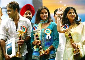 Wimbledon girls doubles winner Sania Mirza is flanked by Bollywood stars