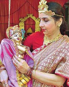 A Brahmakumari carries a statue of Lord Krishna during the Sri Krishan Janmashthmi celebrations at the Brahmakumaris Rajyoga Centre, Sector-21, in Chandigarh