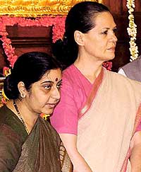 Opposition leader Sonia Gandhi with Parliamentary Affairs Minister Sushma Swaraj at the 59th birth anniversary function of late Rajiv Gandhi at Parliament House in New Delhi on Wednesday. 