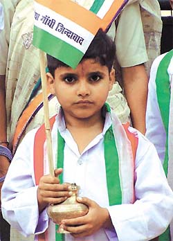A tiny supporter waits for Sonia Gandhi at her residence in the Capital on the 59th birth anniversary of Rajiv Gandhi