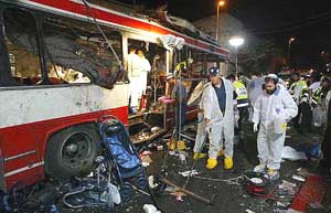 Israeli investigators work at the site of an explosion on a bus in downtown Jerusalem on Tuesday. 