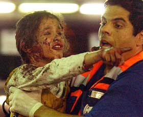 A rescue worker carries an Israeli girl