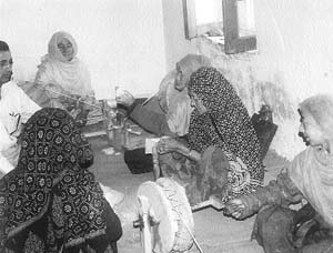 While women spin yarn on charkhas, the weaving of shawls and embroidery is left to men