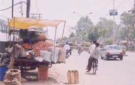 A vegetable seller runs his business from a rehri, oblivious of the inconvenience caused to motorists on Gill Road