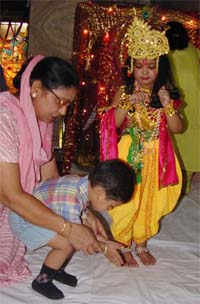 A woman makes her grandson bow before 'Lord Krishna'