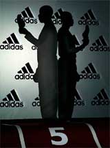 Back-to-back silhouettes of British European champion Dwain Chambers and Olympic champion Maurice Greene of the US