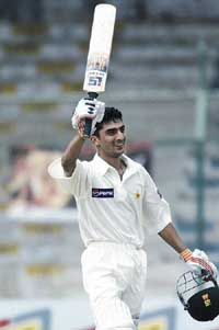 Pakistani debutant Yasir Hameed acknowledges the crowd's applause after reaching his century 