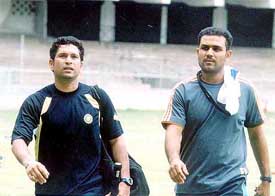 Sachin Tendulkar and Virender Sehwag walk back to the pavilion  after a work-out session in  Bangalore 