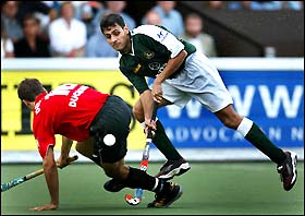 Rehan Butt of Pakistan takes the ball past Eike Duckwitz of Germany 