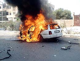 A car burns after it was hit by missiles, fired by an Israeli helicopter in Gaza City 
