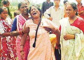 Neighbours try to console the mother of Gopi, who was washed away in a seasonal rivulet in Chandigarh