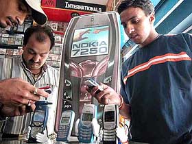 Customers buy mobile phones in Jammu 