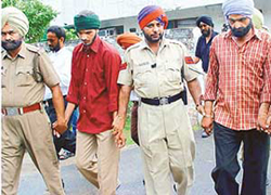 Amritpal Singh (left) and his father Avtar Singh, kidnappers of Harkaran Singh, a resident of Sector 71, SAS Nagar, being produced in the office of the Superintendent of Police in SAS Nagar on Tuesday.