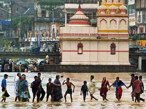 Pilgrims cross the Godavari at Ram-Ghat in Nasik during the Kumbh Mela on Tuesday. The second "Shahi Snan" is to take place on Wednesday at Nasik and Trimbkeshwar.