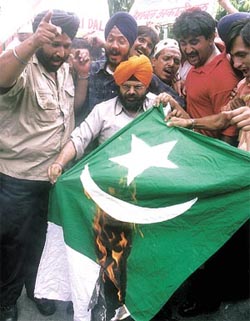 Activists of the National Akali Dal burn the flag of Pakistan in protest against the ISI�s alleged involvement in the Mumbai bomb blasts at Jantar Mantar