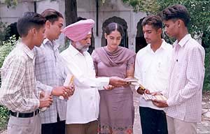 English teacher Nachhattar Singh with some of the successful students