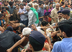 Devotees fall as they try to break through police barricades, resulting in a stampede during the third "Shahi Snan" at the Kumbh Mela in Trimbakeshwar, near Nashik, on Wednesday.