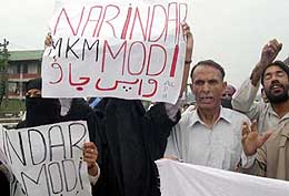 Protesters hold up anti-Narendra Modi posters at a demonstration in Srinagar 